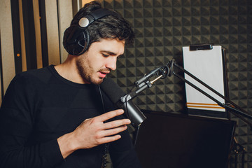 Microphone in radio studio and presenter on background