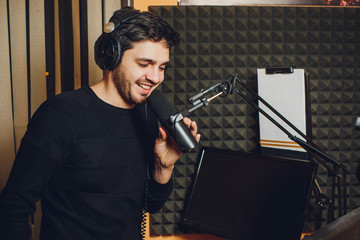 Microphone in radio studio and presenter on background