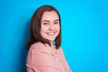 Fototapeta premium Beautiful smiling woman on color background