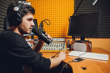Microphone in radio studio and presenter on background