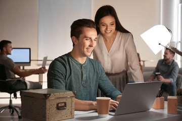 Young co-workers having late night meeting in office