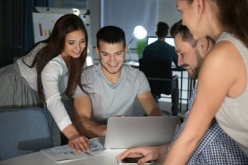 Group of young professionals having late night meeting in office