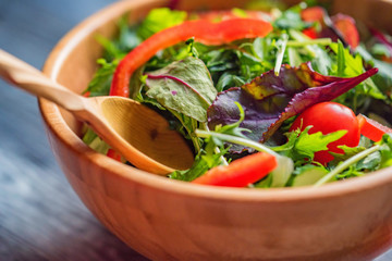 Fresh rustic vegetable salad on rustic background