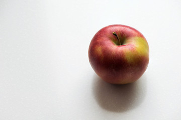 Red and yellow apple contrast lighting on white background