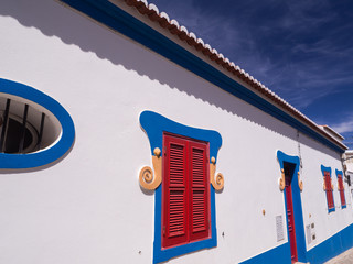 PORTIMAO, PORTUGAL - AUGUST 30, 2016: Colourful Portuguese Building in Blue Red and White