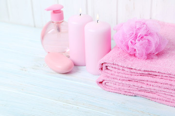 Obraz na płótnie Canvas Pink towels with soap and wisp on white wall paneling background