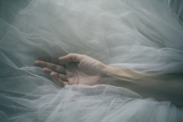 Female hand and arm over tulle background - Woman hand - Serenity, simplicity, giving and health...