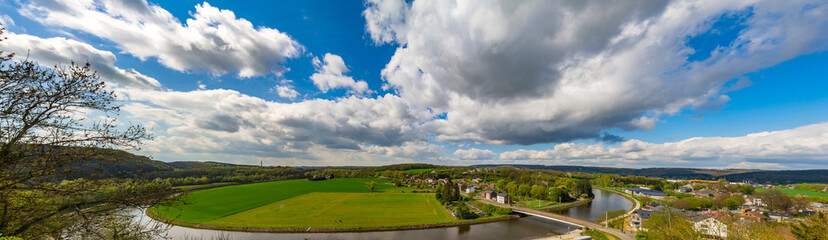 River looping around the green fields, summer day