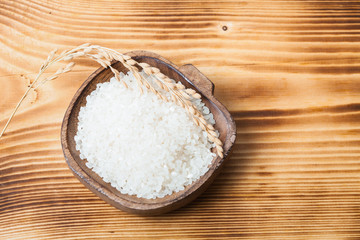 Raw rice on wood desk 