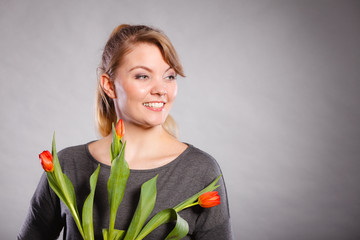 Smiling female holding boquet.