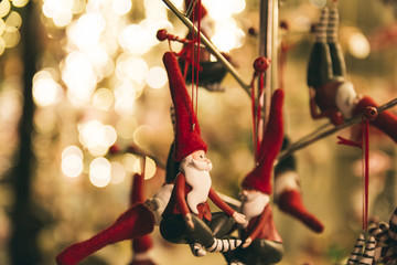 Fototapeta na wymiar Santa Claus Christmas ornaments hanging on a branch in a Christmas market stall, Germany - Xmas decoration