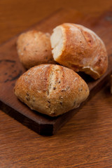 fresh baked bread with cereals on cutting board on wooden table