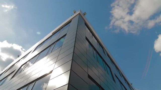 Clouds reflected in mirrored facets of modern office building