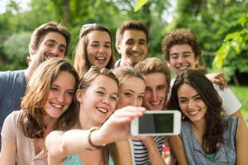 Group of young people taking a selfie outside