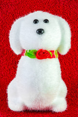 plush soft white toy dog isolated on red background
