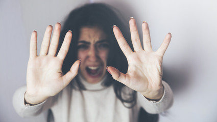 battered  woman hands stop sign