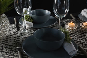 Elegance table setting with empty wine glasses and lit candle