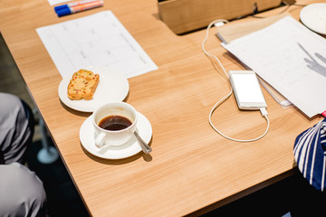Business people working on laptop computer and phone in meeting room