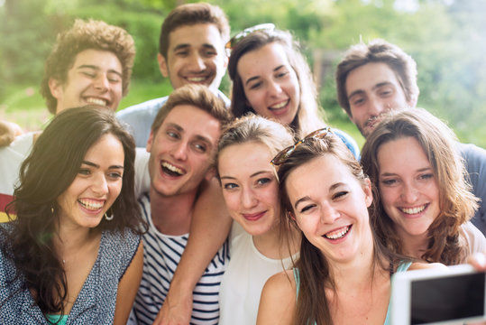 Group of young people taking a selfie outside