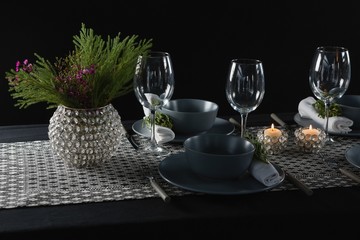 Elegance table setting with empty wine glasses and lit candle