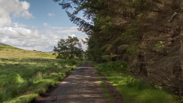 hyperlapse POV shot from a camera attached to the front of a vehicle driving through beautiful empty roads in the scottish highlands