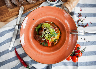 beautifully served baked potatoes with meat on a plate and striped napkin
