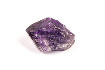 Raw purple crystal stone isolated on white background