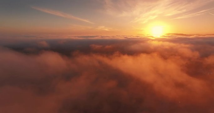 Aerial view epic low clouds over California Pacific Coast sunset flying backward