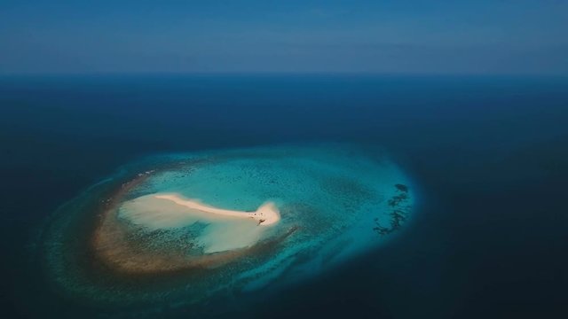 Aerial view of beautiful sand tropical island with white sand beach. White sand island. Beautiful sky, sea ,resort. Seascape: ocean and beautiful beach paradise. Philippines, Camiguin. 4K video