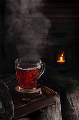 cup of boiling black tea in winter decorations