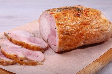 Homemade meatloaf from pork meat with spices on cutting board.