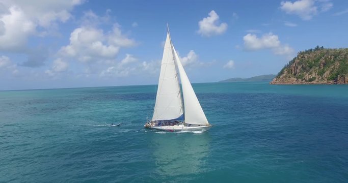 WHITSUNDAY ISLANDS – FEBRUARY 2016 : Aerial shot of sailing boat on a beautiful day with open ocean and amazing landscape in view