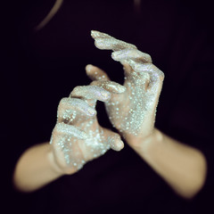 Beautiful woman hands with glister, glitter or fairy dust close up