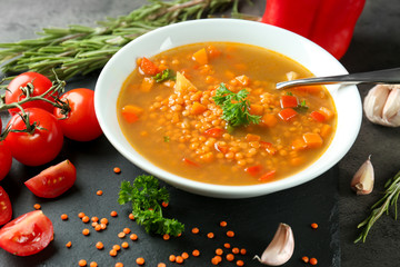 Dish with tasty lentil soup on table