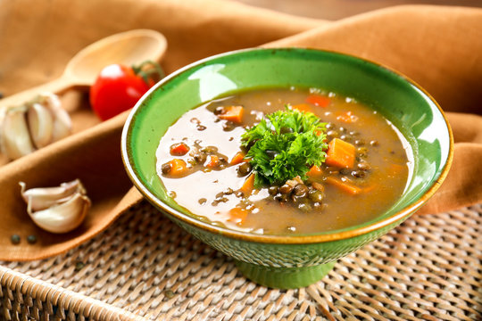 Dish with tasty lentil soup on tray