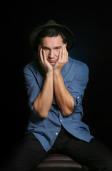 Attractive young man on black background