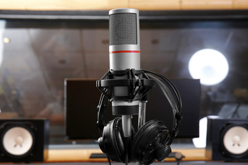 View of microphone with headphones in radio station