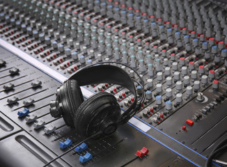 Headphones on mixer in radio station