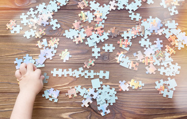 collecting puzzles on the background of a wooden table