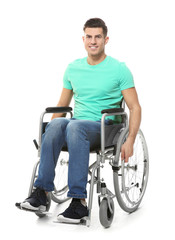 Fototapeta na wymiar Young man in wheelchair on white background