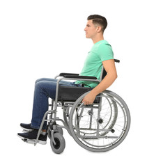 Young man in wheelchair on white background