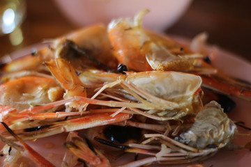 grilled shrimps in bowl on wooden table