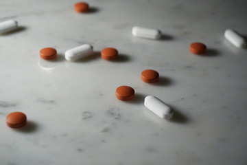 Isolated pills on white marble