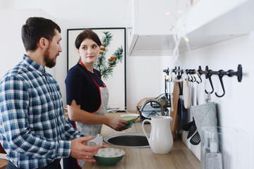 Male and female chefs working at kitchen