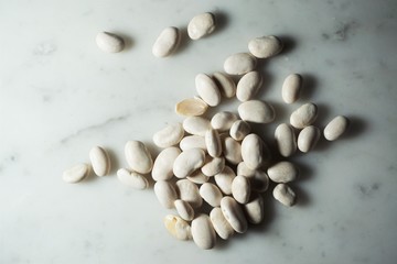 Isolated white beans on white marble