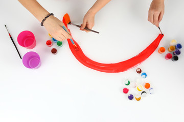 baby hand paint a rainbow on a white background.