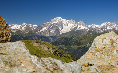 Fototapeta na wymiar Hiking in Aosta valley, Italy. View of Mont Blanc Massif with clear blue sky from Tsa Seche col.