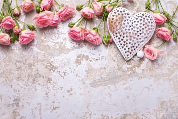 Fototapeta na wymiar Decorative heart and tender rose flowers