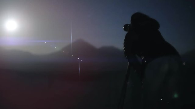 Silhouette of photographer taking photos to full moon. 4k
