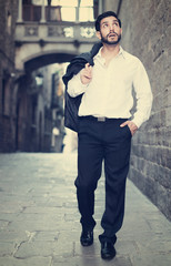 Obraz premium Man in formalwear walking along street